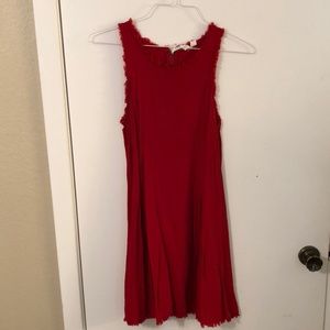Red dress with frey on top and bottom of dress.